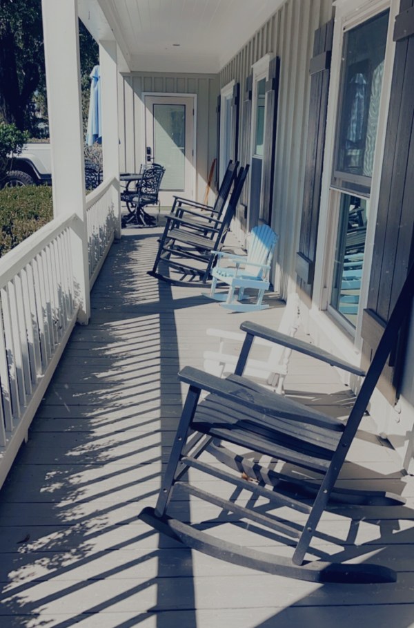 Rocking chairs lined up on the front porch at Sweet Water Dentistry
